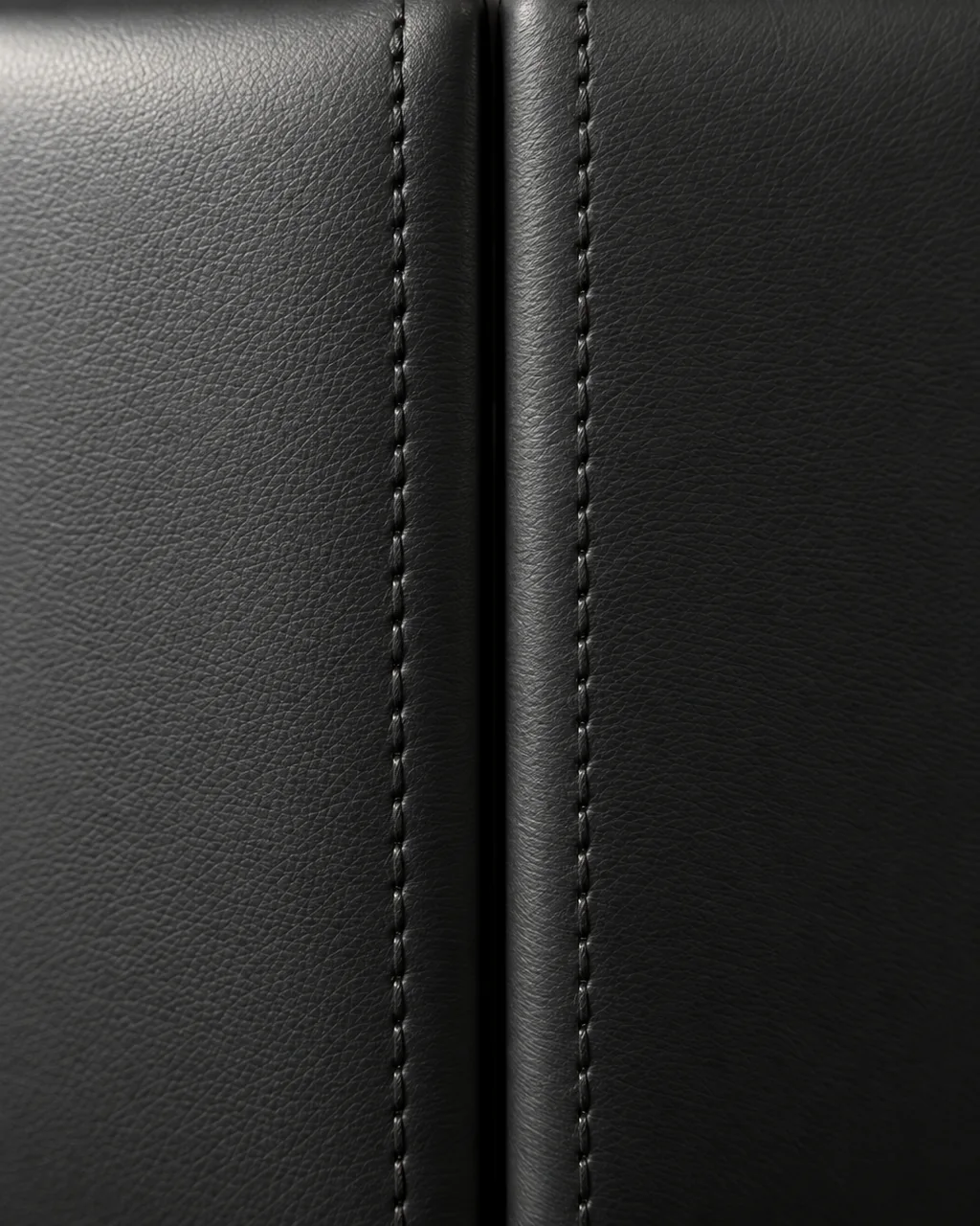 Two padded faux leather panels side by side, stitched edges and gap